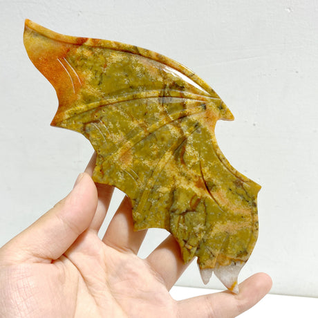 Yellow Ocean Jasper Demon And Angel Wing Carving With Stand